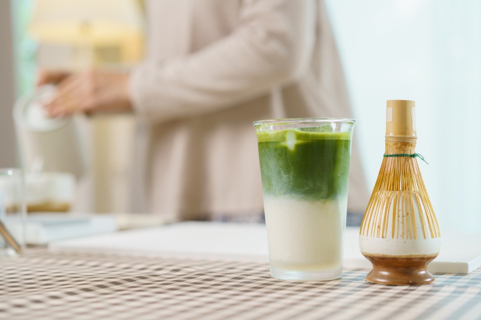 Café staff measuring matcha beverage powder ingredient to a branch preparation standard