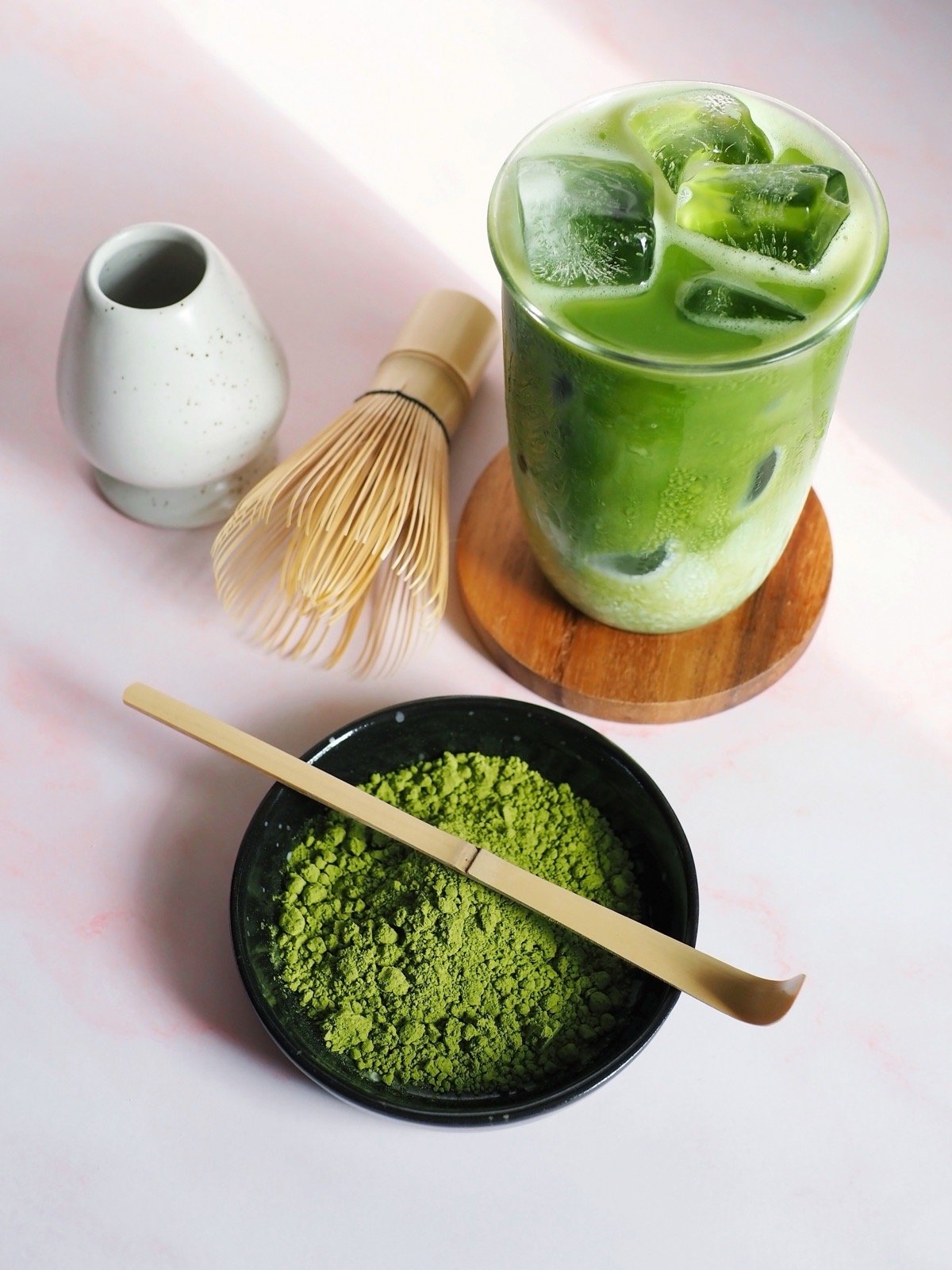 Dry matcha beverage powder ingredient beside a prepared beverage application example